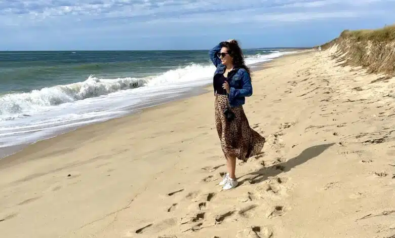 Kate stands on a sandy beach in Martha