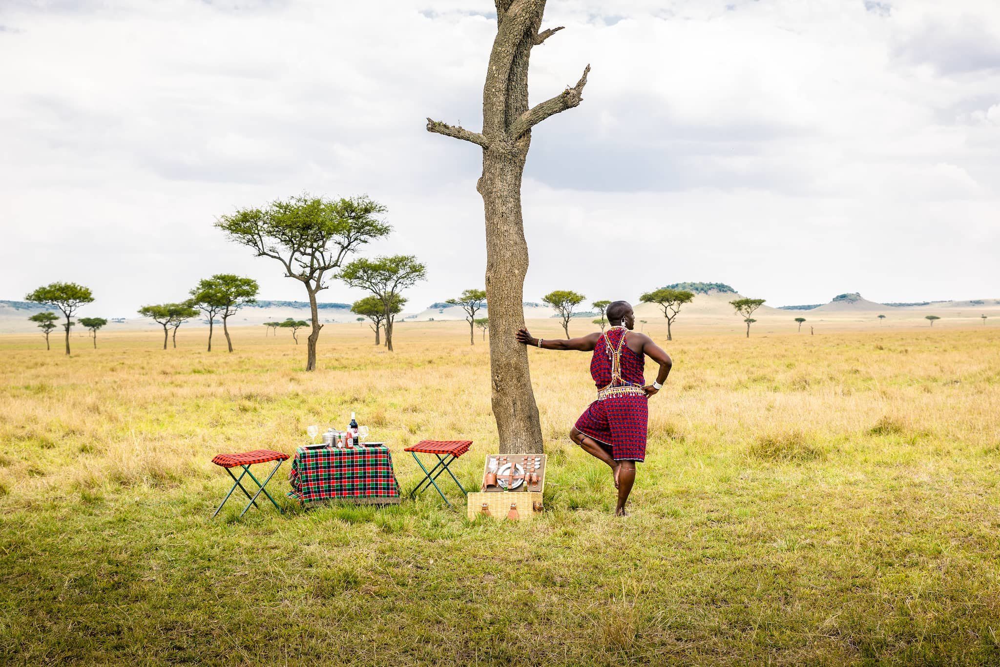 Guerrero masai apoyado en un árbol
